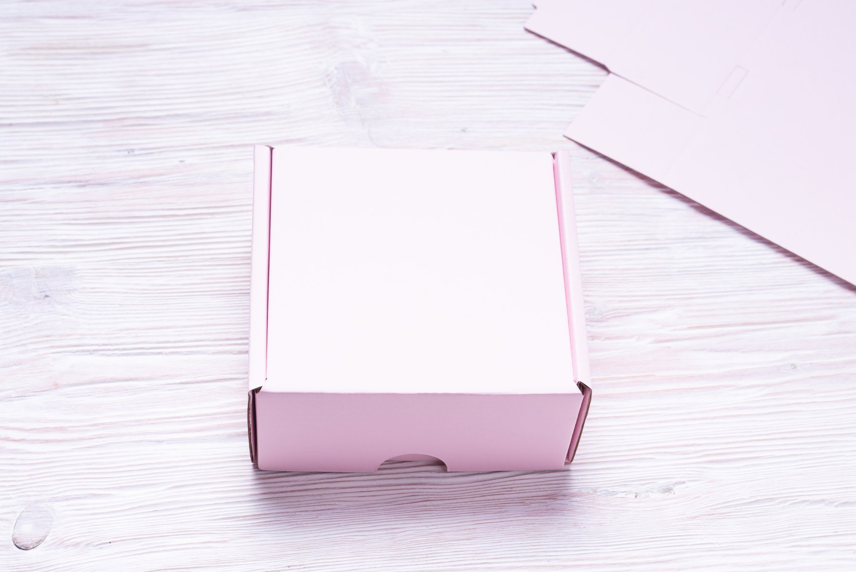 Box on Pink Wooden Background